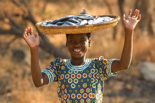 Lady with fish basket on head Malawi MTB