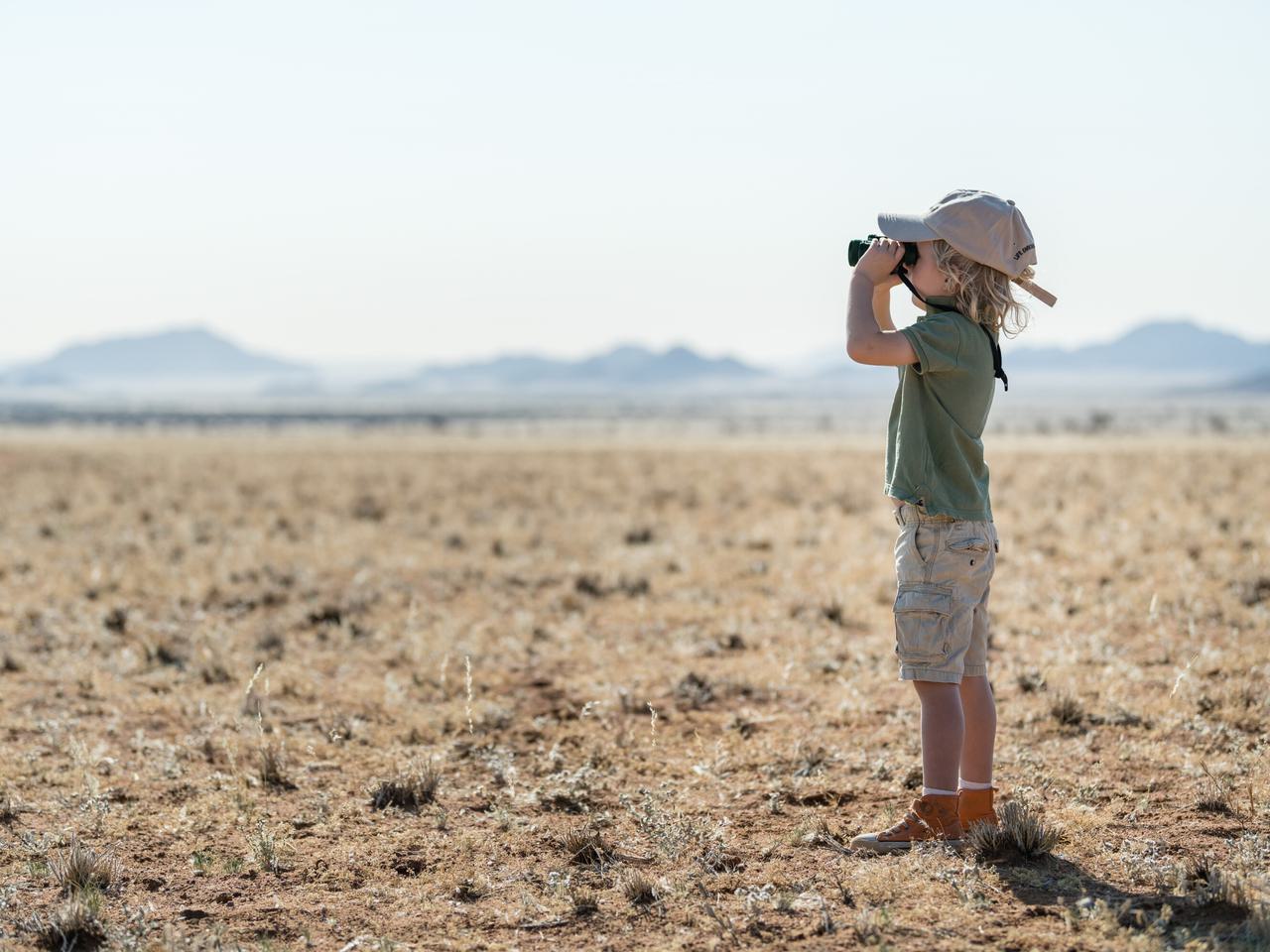 Child with binoculars at Camp Sossus