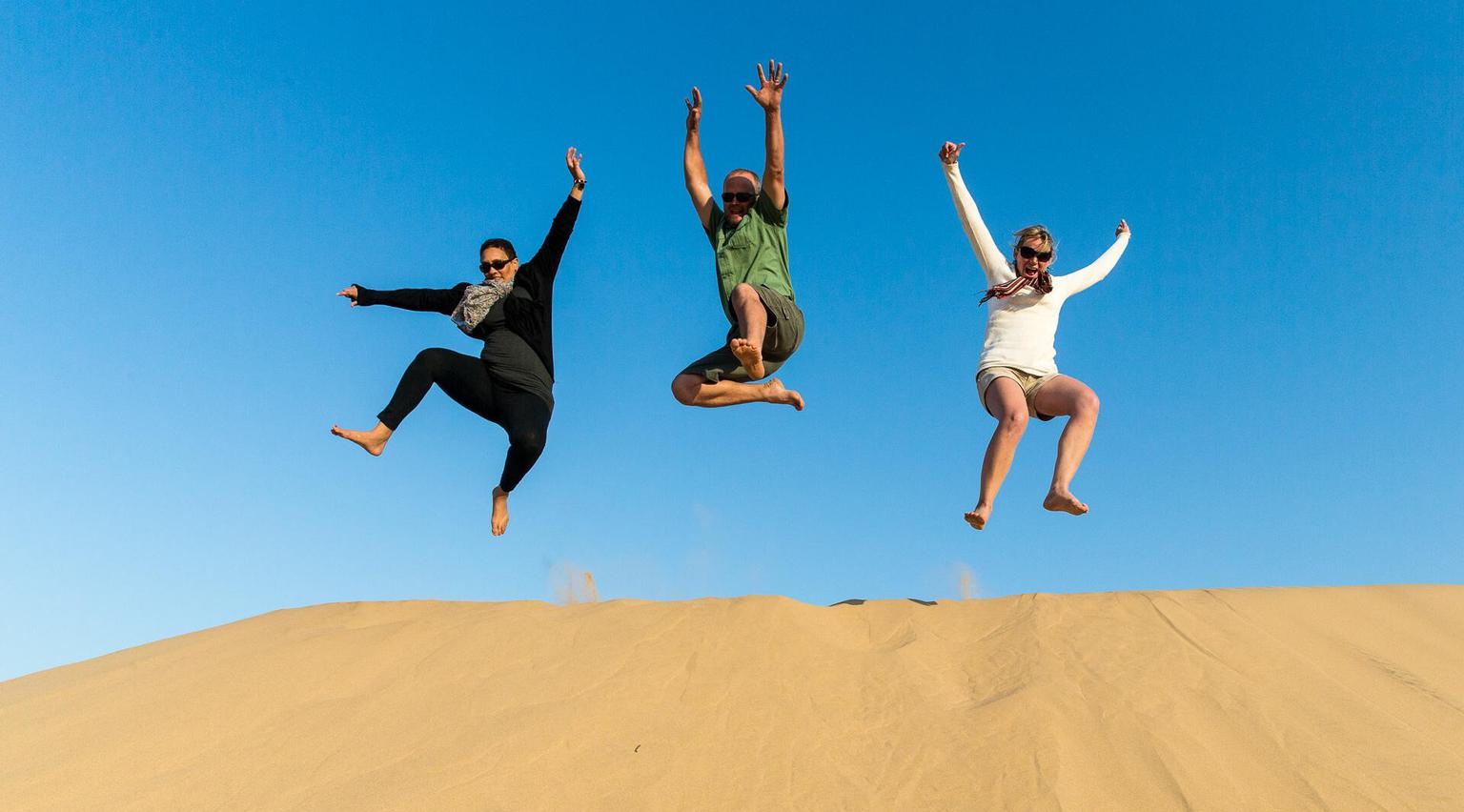 Jumping down sand dunes Wilderness Hoanib Skeleton Coast Camp