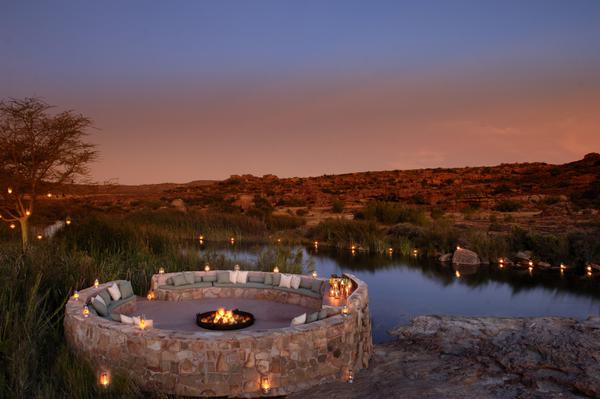 Lit boma with candles at sundown, orange and purple-hued sky in background.