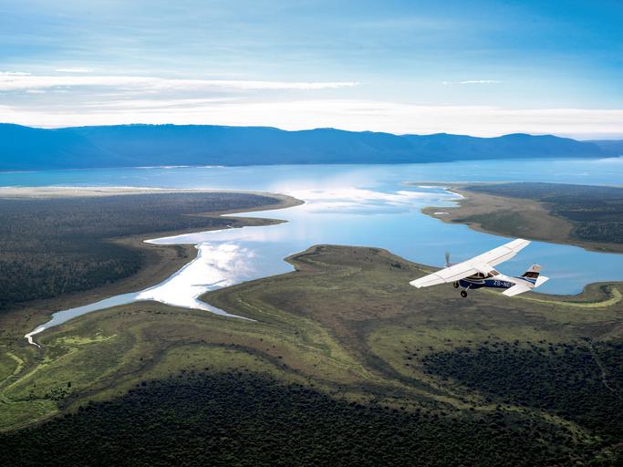 Plane flying over lake at Phinda KZN SAT