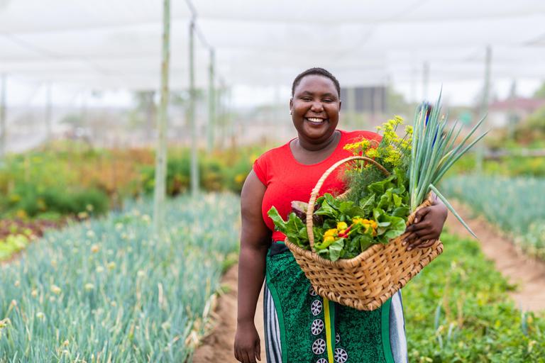 Virbrant smiling lady in community vegetable garden Thornybush