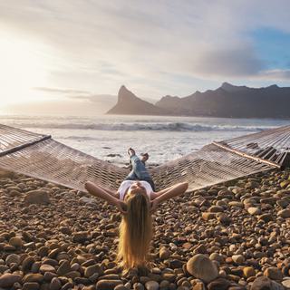 Woman relaxing on hammock with view of Hout Bay SAT