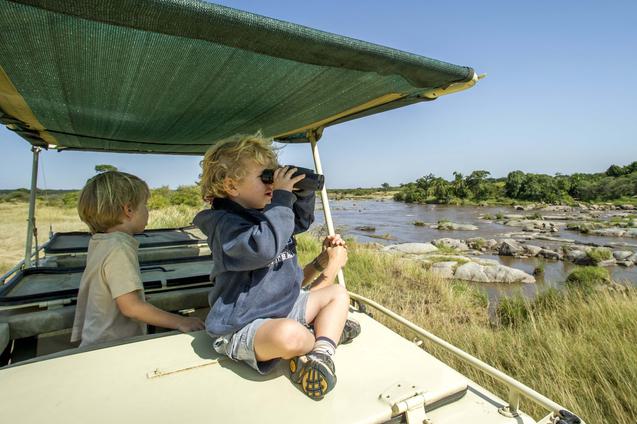 Children on game vehicle with binoculars nomad mkombes house