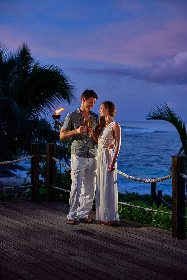 Couple at night drinks on deck PORTRAIT
